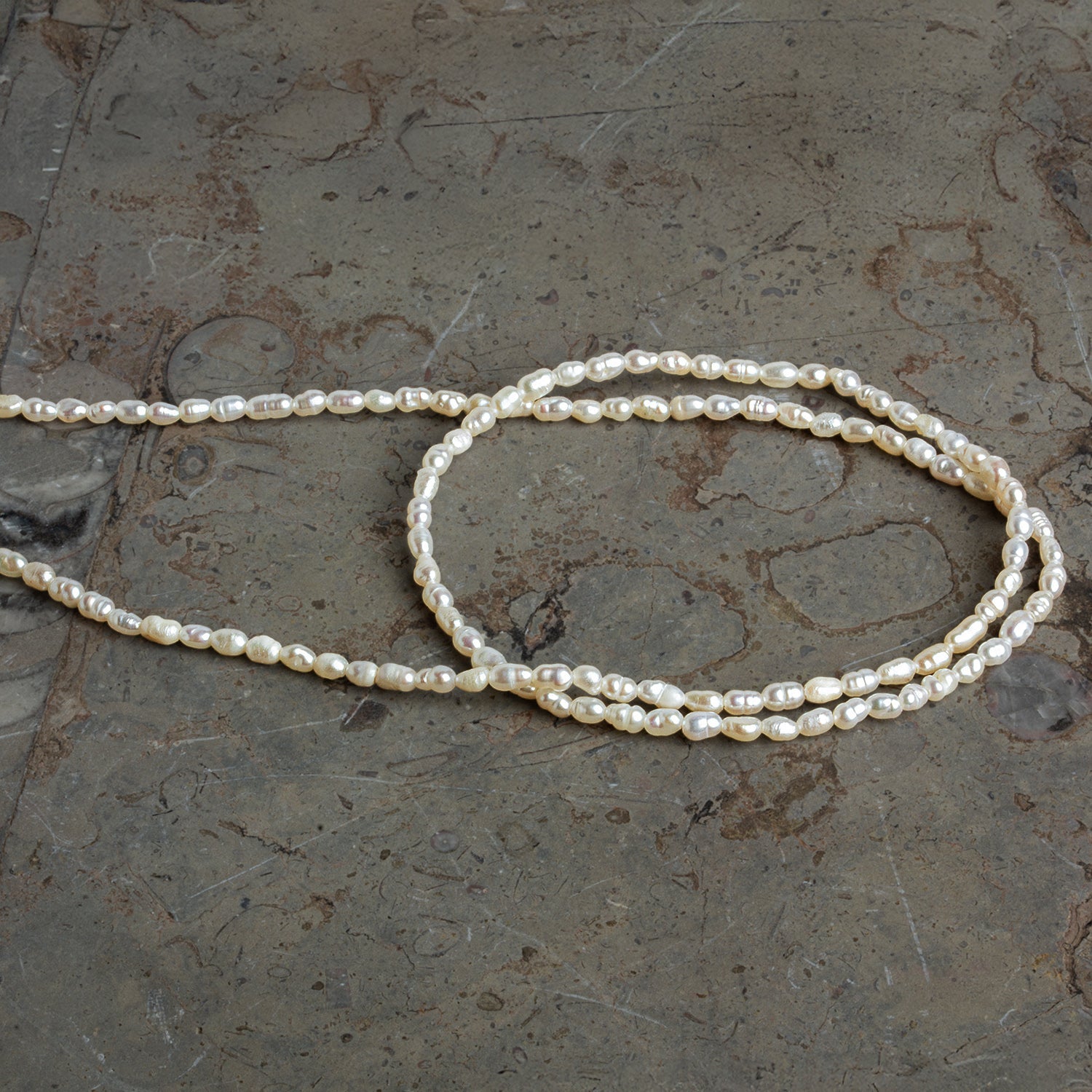 3x2mm Off White Baroque Rice Pearls 16 inch 95 beads - The Bead Traders