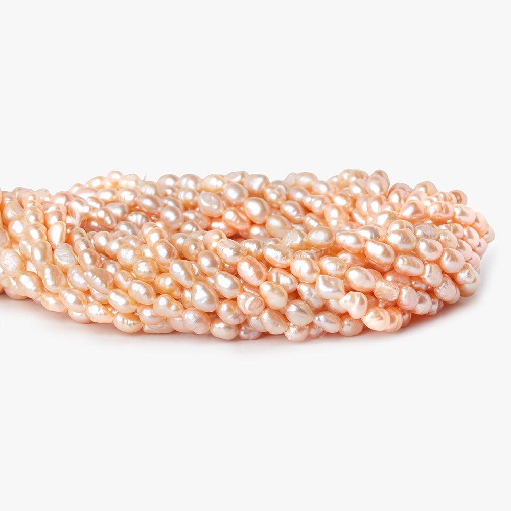 Peach Petite Baroque Freshwater Pearl 16 inch 50 pieces 5x4mm - 7x4mm - The Bead Traders