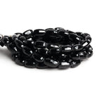 13x8mm Black Spinel Faceted Barrels 16 inch 38 beads - The Bead Traders