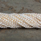 3x2mm Off White Baroque Rice Pearls 16 inch 95 beads - The Bead Traders