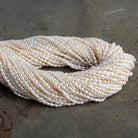 3x2mm Off White Baroque Rice Pearls 16 inch 95 beads - The Bead Traders