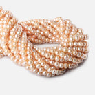 6 - 7mm Creamsicle Orange Large Hole Off Round Pearls 15 inch 75 beads - The Bead Traders