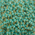 3mm Turquoise Crystal rondelle Gold Dangling Chain by the foot 97 beads - The Bead Traders