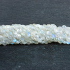 5-8mm Rainbow Moonstone Faceted Coins 16 inch 64 beads - The Bead Traders